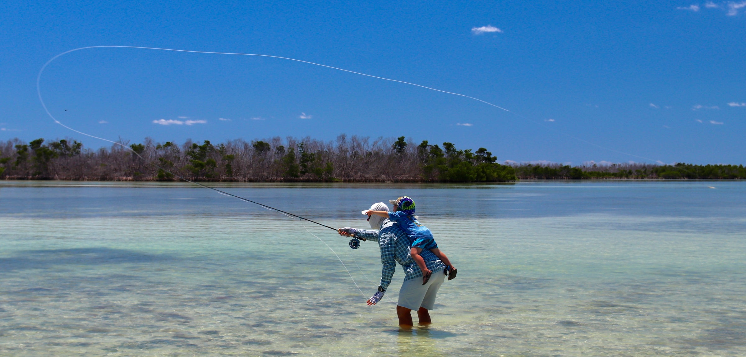 Fly fishing with kid on your back, shallow water, sunny day